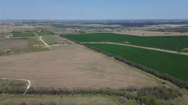 an aerial view of a houses with a yard