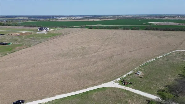 a view of a field with an ocean view