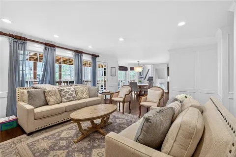 a view of a dining room with furniture and a chandelier