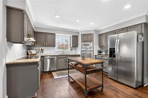 a kitchen with a stove a sink and a refrigerator
