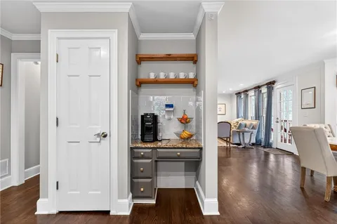 a living room with fireplace furniture and a large window