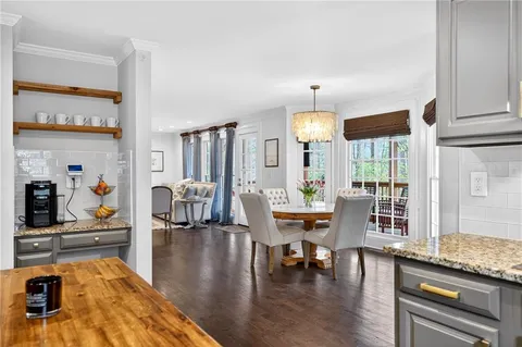 a view of a porch with furniture and wooden floor