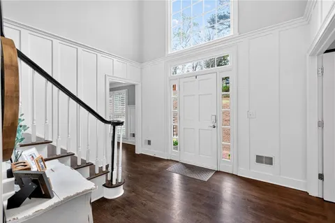 a view of a hallway with windows and wooden floor