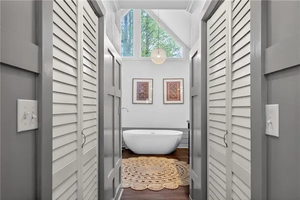 a white bath tub sitting next to a white toilet
