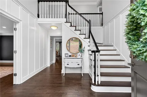 a view of entryway and hall with wooden floor
