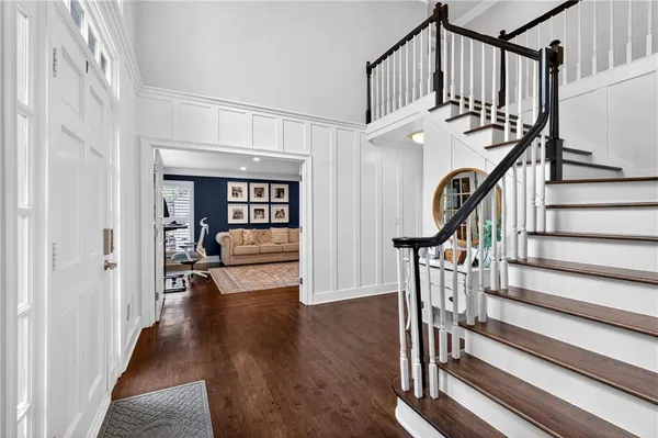 a view of entryway and hall with wooden floor