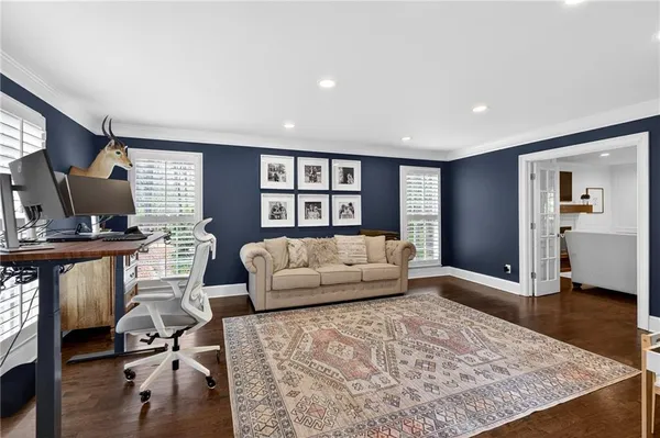 a living room with furniture and wooden floor