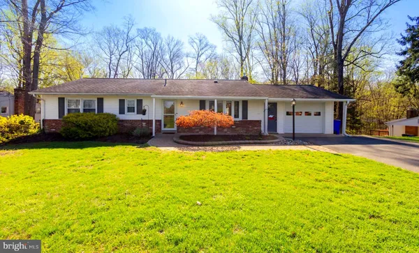 a front view of a house with a garden and swimming pool