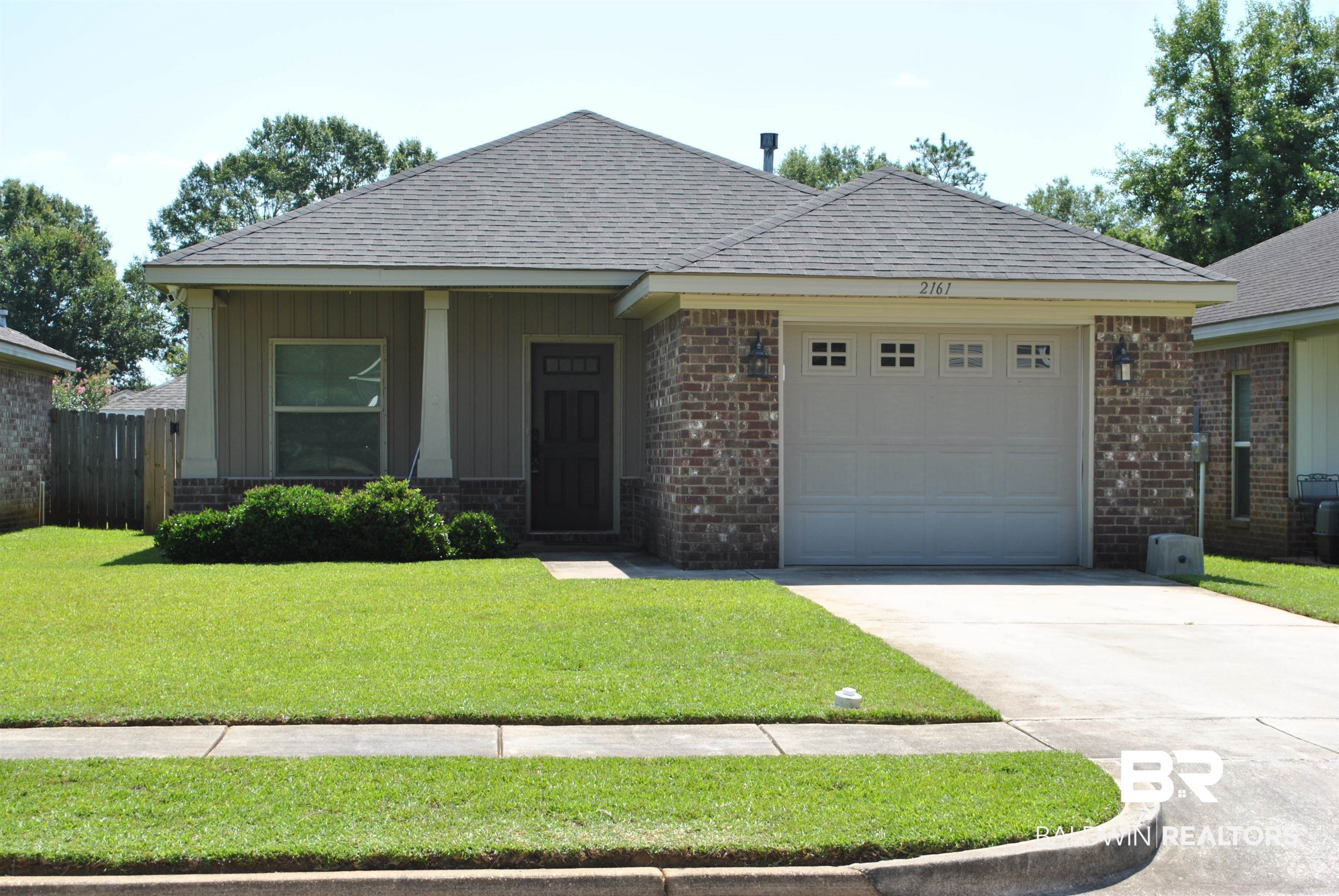 2161 Spring Grove West Mobile, AL 36695 - Photo 2 of 31 View of front of home featuring brick siding, an attached garage, concrete driveway, and roof with shingles