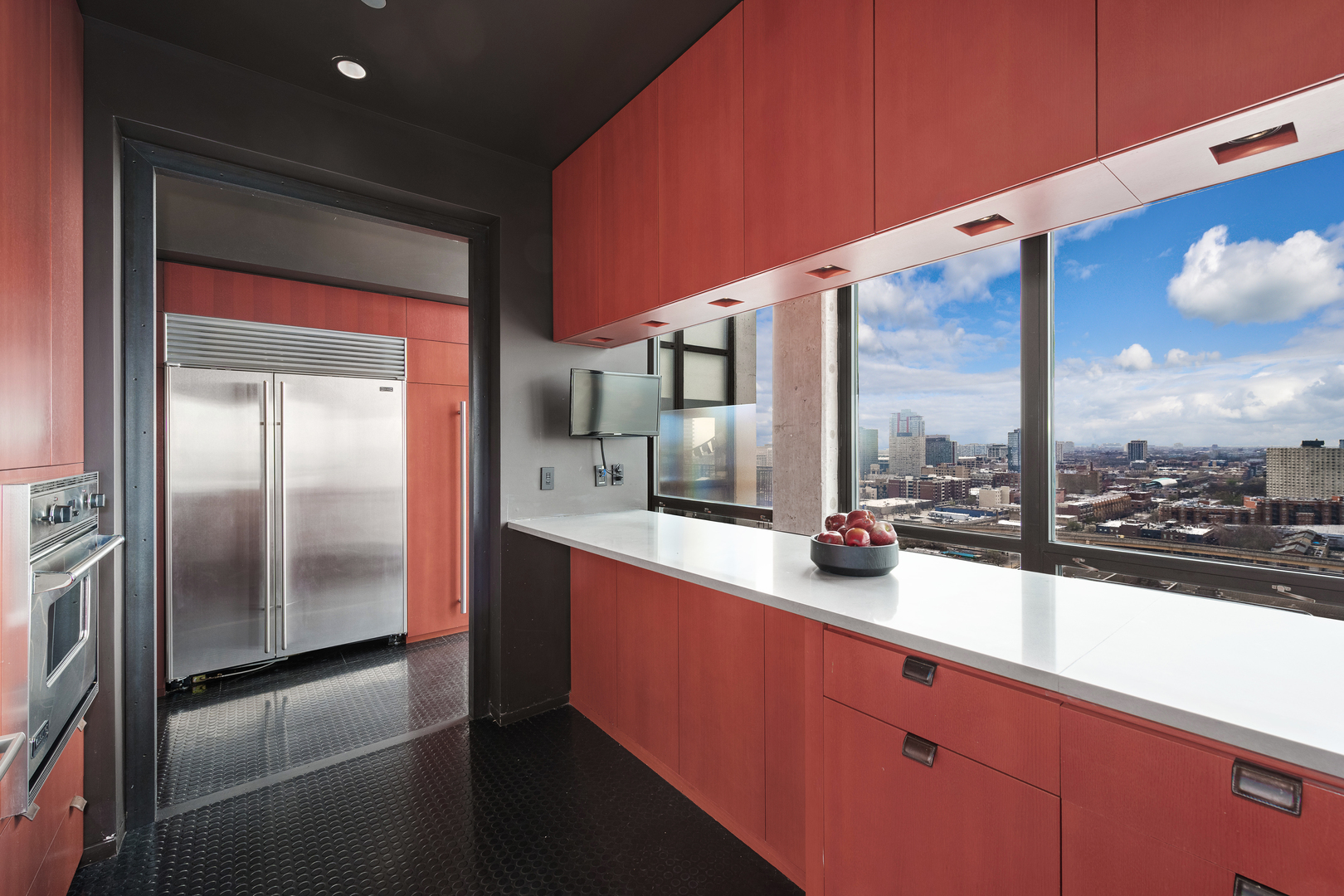 1530 South State Street, Unit 18AB Chicago, IL 60605 - Photo 13 of 54 a kitchen with stainless steel appliances kitchen island granite countertop a refrigerator a sink and counter space