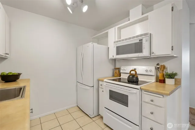 a living room with furniture and potted plants