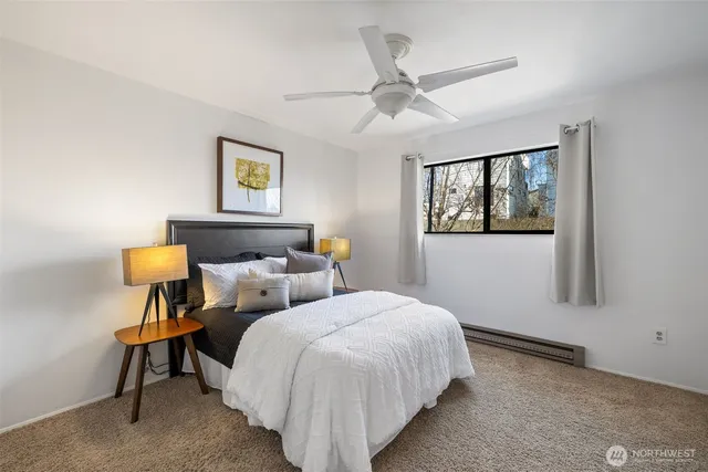 a bedroom with a bed and a lamp on table