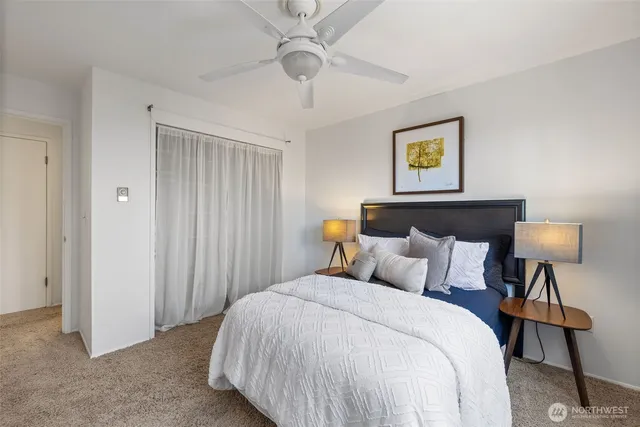 a bedroom with a bed couch and window