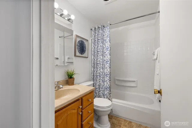a bathroom with a sink a toilet and mirror