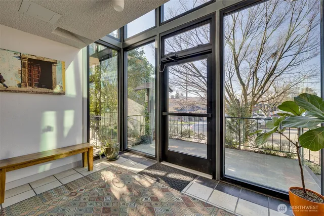 a spacious bedroom with a large window and a bed