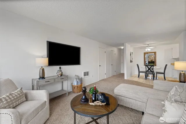 a living room with furniture and a potted plant