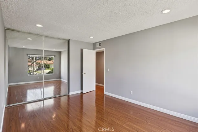 a view of room with window and wooden floor