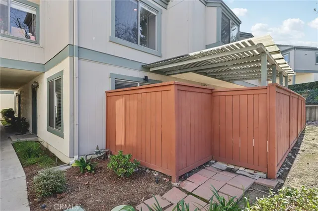 a view of an empty room with wooden floor fireplace and a window