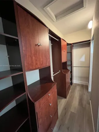 a kitchen with a refrigerator and a stove top oven