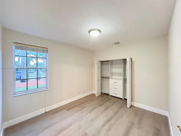 an empty room with a empty space and windows