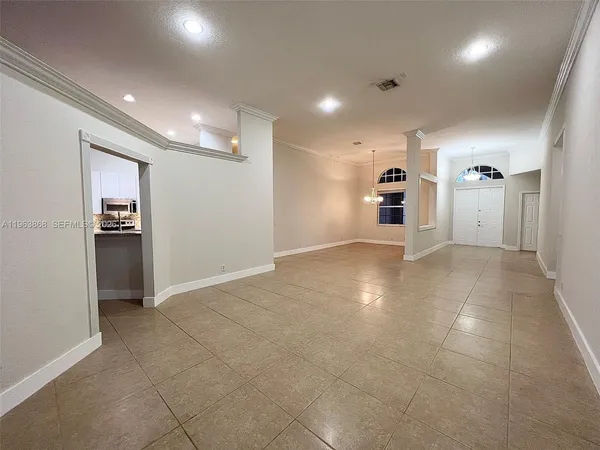 a view of a livingroom with furniture and a refrigerator