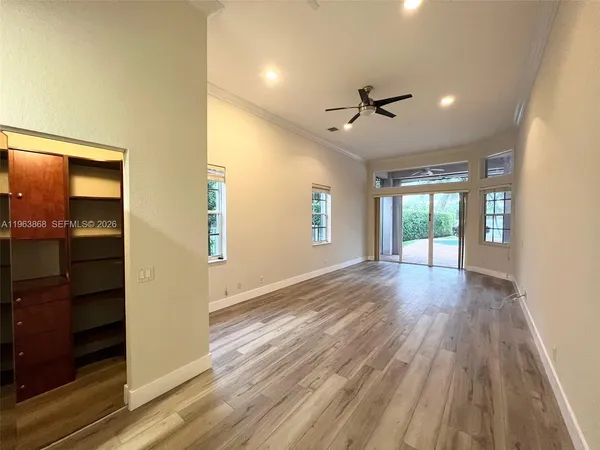 wooden floor in an empty room with a window