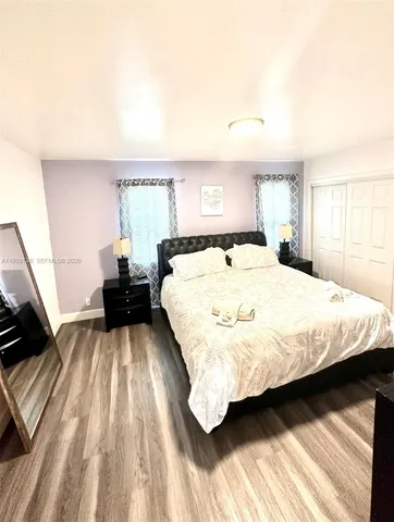 a bedroom with a bed and a view of kitchen