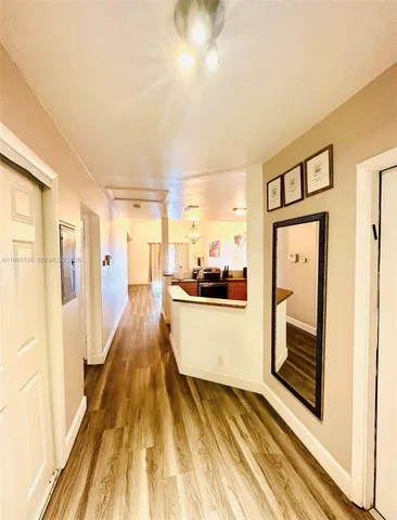 a view of a hallway view with wooden floor and staircase