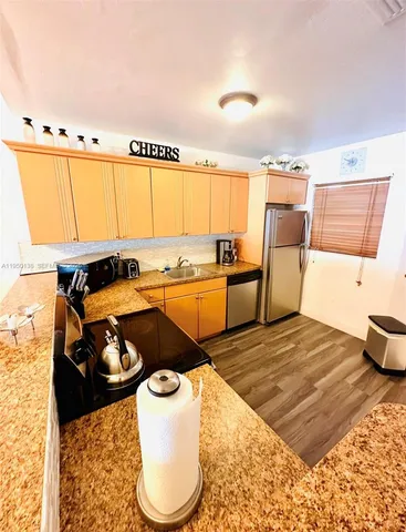 a kitchen with a sink a stove and a refrigerator