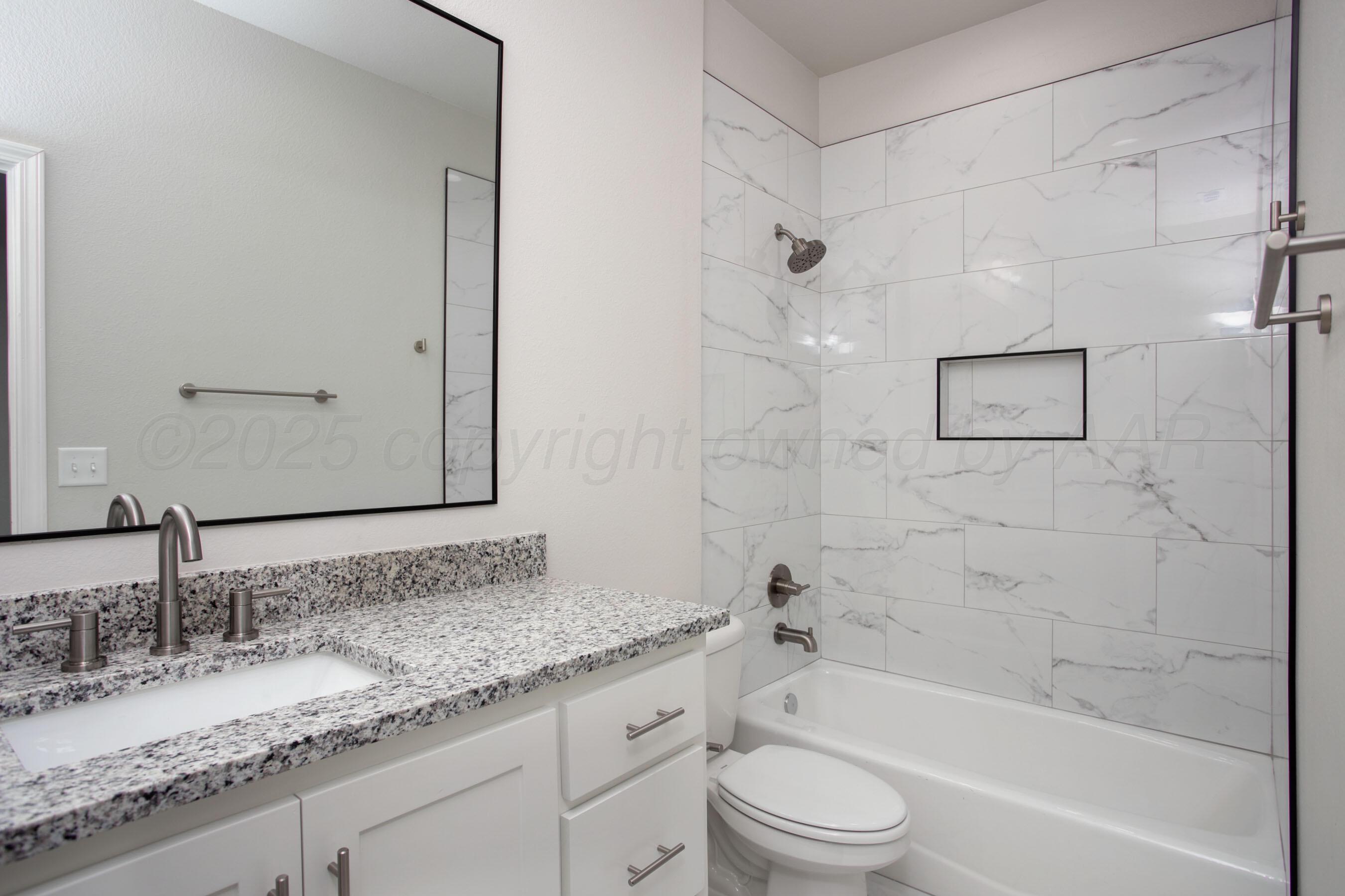 22131 Howard Draw Rd Canyon Canyon, TX 79015 - Photo 17 of 25 a bathroom with a granite countertop sink a toilet and bathtub