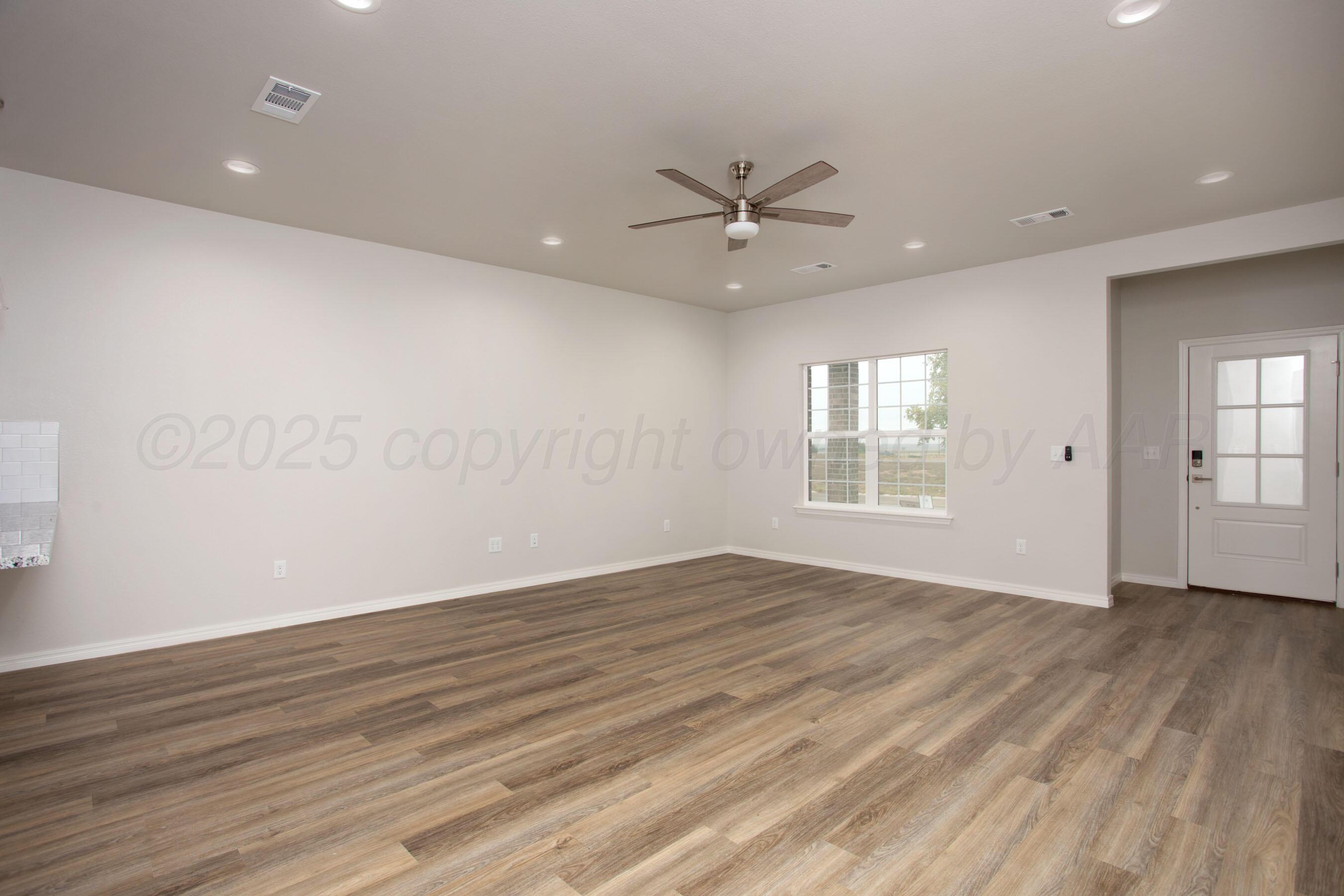 22131 Howard Draw Rd Canyon Canyon, TX 79015 - Photo 9 of 25 a view of an empty room with wooden floor and a window
