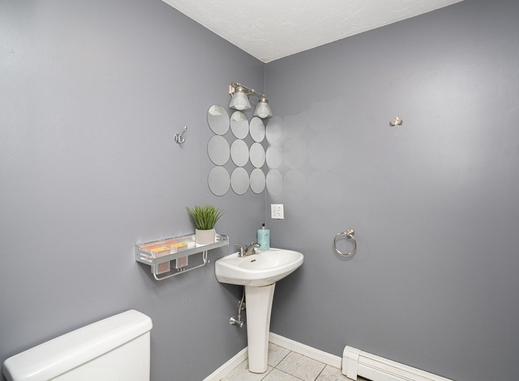 2 Toni Lane Franklin, MA 02038 - Photo 12 of 24 a bathroom with a sink a toilet and a mirror