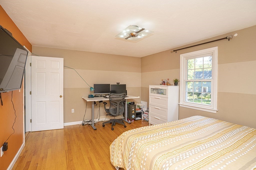 2 Toni Lane Franklin, MA 02038 - Photo 16 of 24 a bedroom with a bed and a chandelier