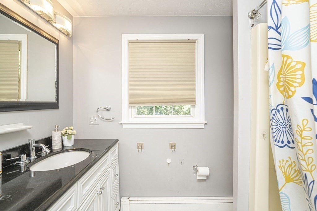 2 Toni Lane Franklin, MA 02038 - Photo 19 of 24 a bathroom with a granite countertop sink and a mirror