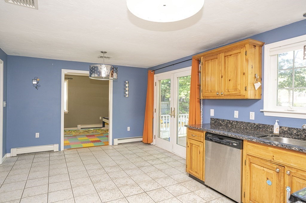 2 Toni Lane Franklin, MA 02038 - Photo 9 of 24 a kitchen with stainless steel appliances granite countertop a refrigerator and cabinets