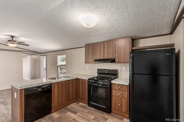 a kitchen with a refrigerator stove and sink