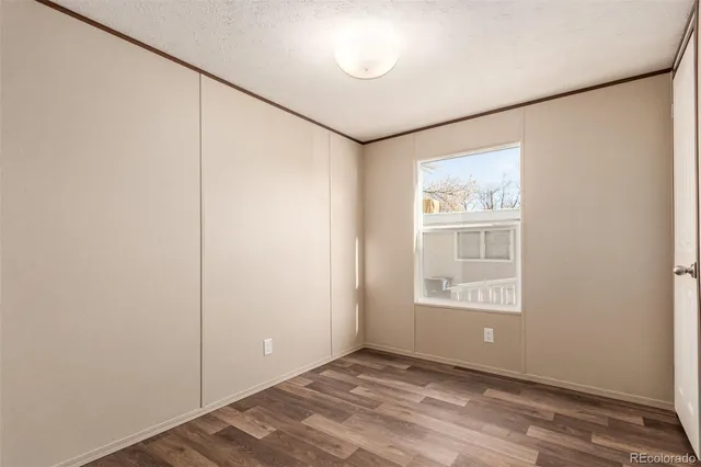 an empty room with windows and closet