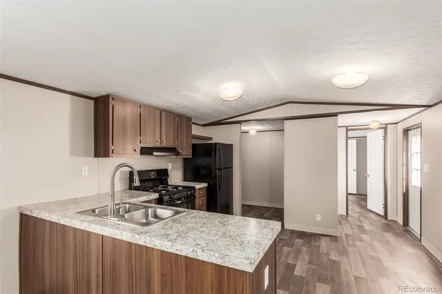 a kitchen with kitchen island a sink stove and refrigerator