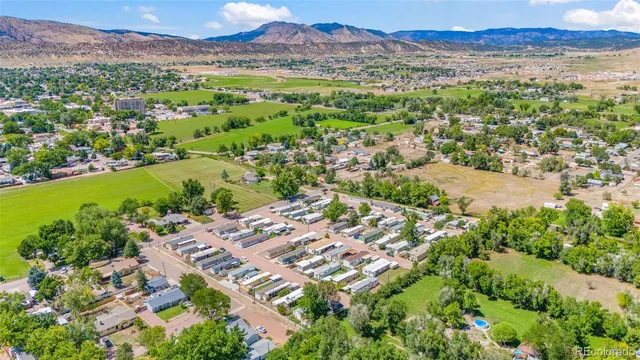 a view of a lush green hillside and houses