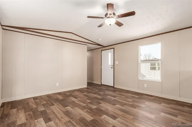 a view of a big room with a ceiling fan and a window