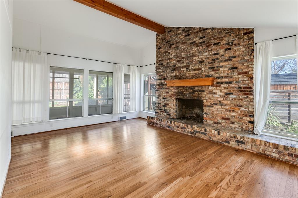 9759 Shoreview Road Dallas, TX 75238 - Photo 7 of 17 Gas FP; view through windows to sunroom. Beautiful hardwoods.