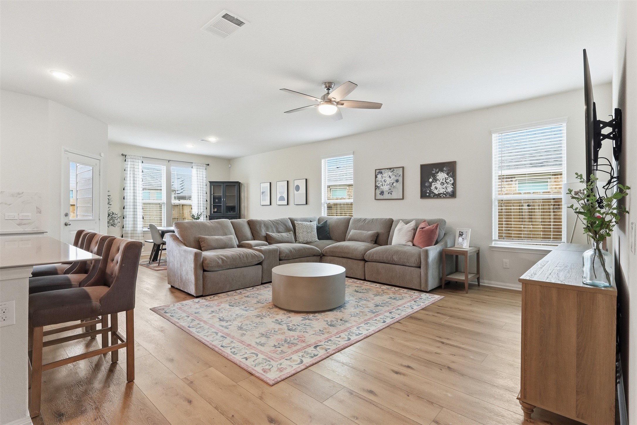 9739 Birdsnest Court Spring, TX 77379 - Photo 7 of 38 Spacious and light-filled family room showcasing recently updated luxury vinyl plank flooring and an open layout perfect for everyday living and entertaining.