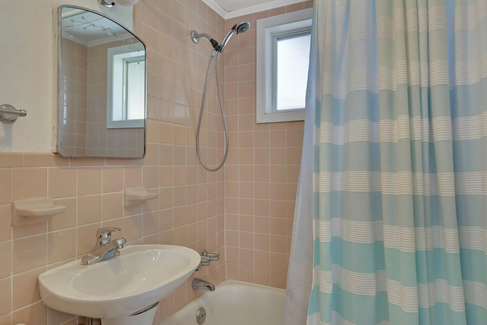 11 Oakhurst Road Hampton Bays, NY 11946 - Photo 13 of 20 a bathroom with a sink a toilet and shower