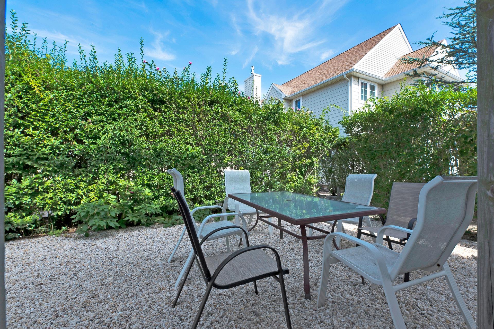 11 Oakhurst Road Hampton Bays, NY 11946 - Photo 17 of 20 a view of a chairs and table in the backyard