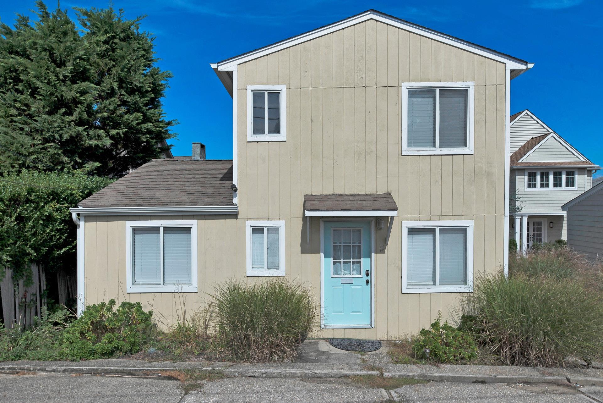 11 Oakhurst Road Hampton Bays, NY 11946 - Photo 3 of 20 a front view of a house with a yard