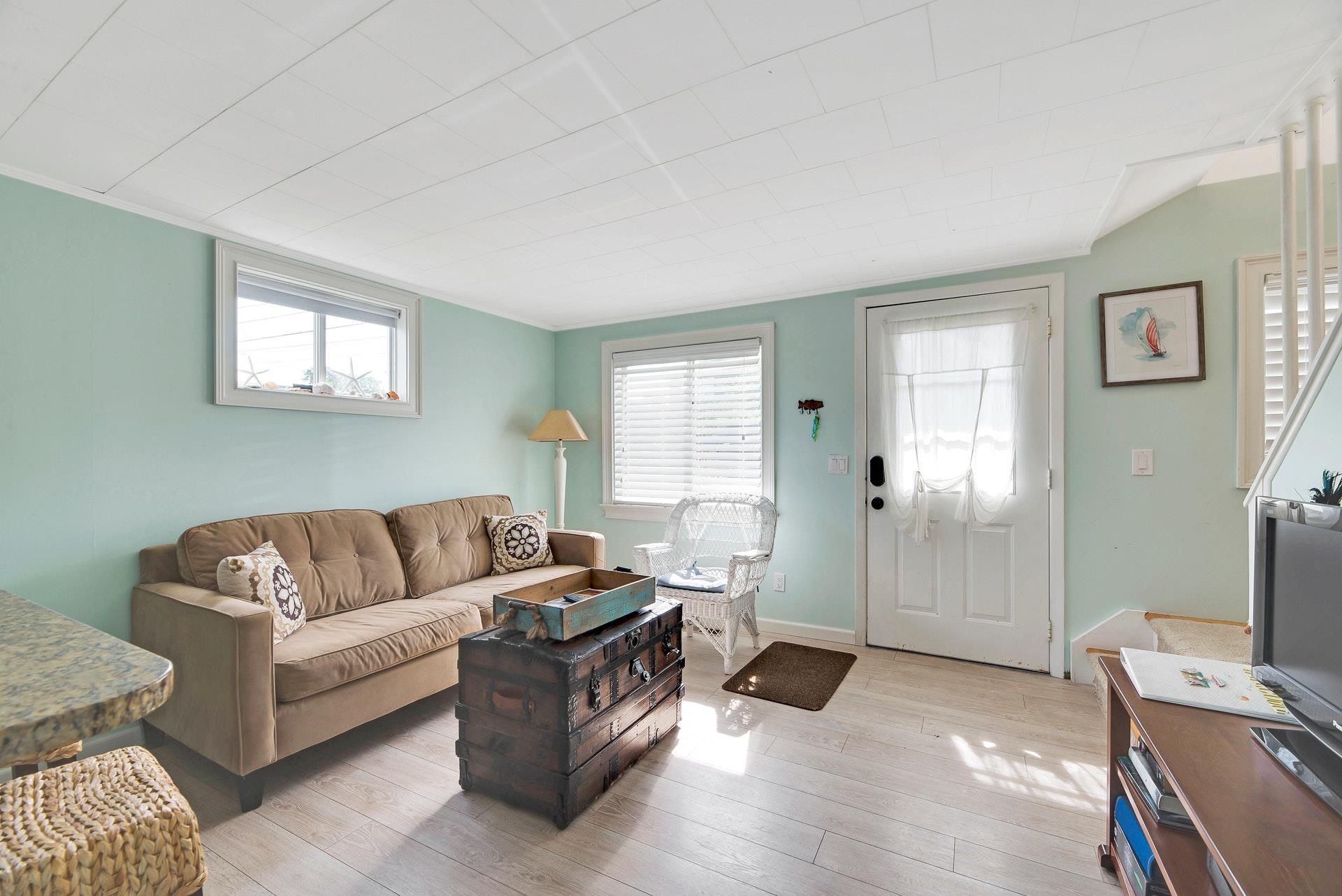 11 Oakhurst Road Hampton Bays, NY 11946 - Photo 6 of 20 a living room with furniture and a flat screen tv