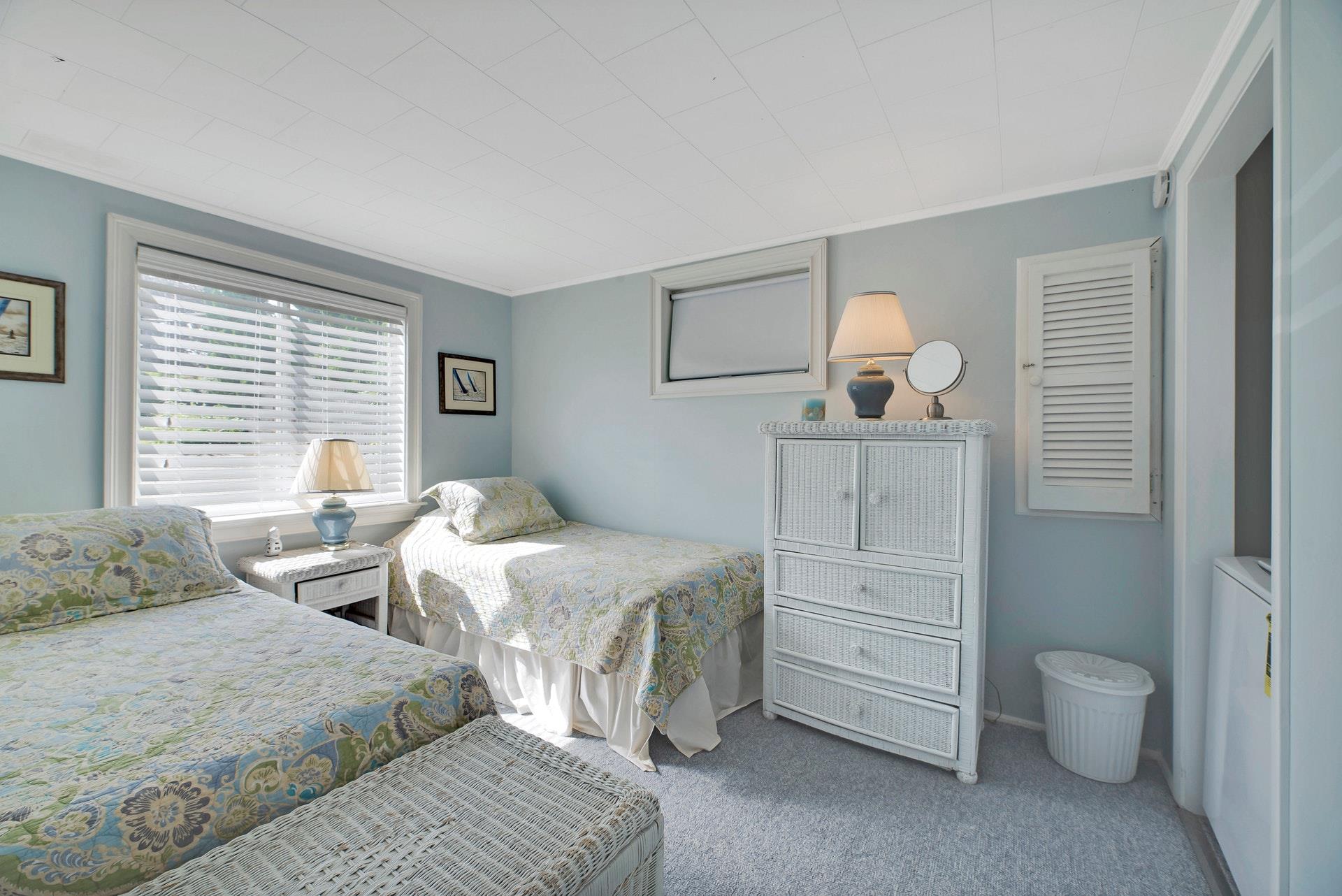 11 Oakhurst Road Hampton Bays, NY 11946 - Photo 9 of 20 a bedroom with two beds and painting on the wall