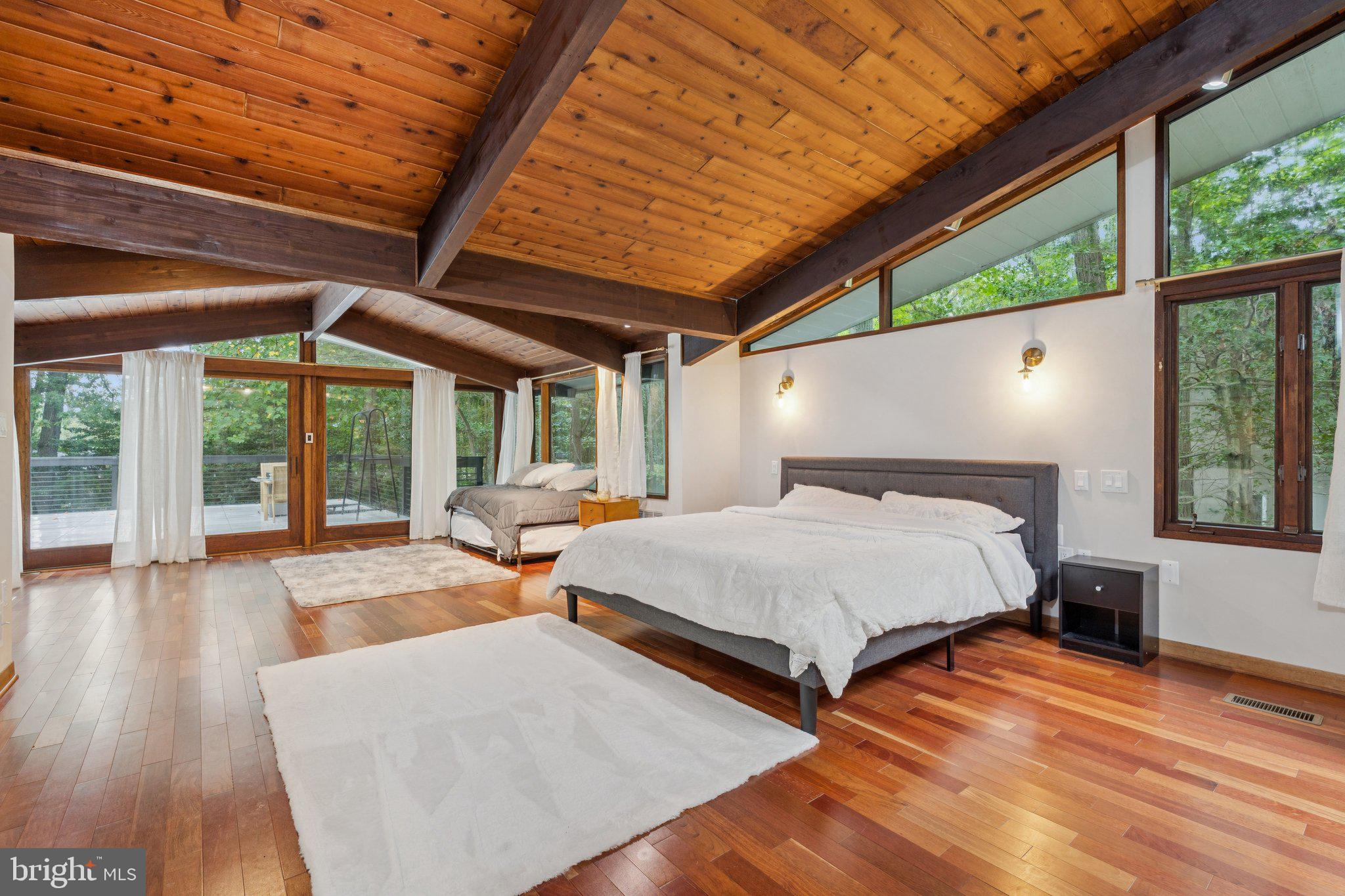 11428 Purple Beech Drive Reston, VA 20191 - Photo 17 of 52 a bed sitting in a spacious bedroom next to a window