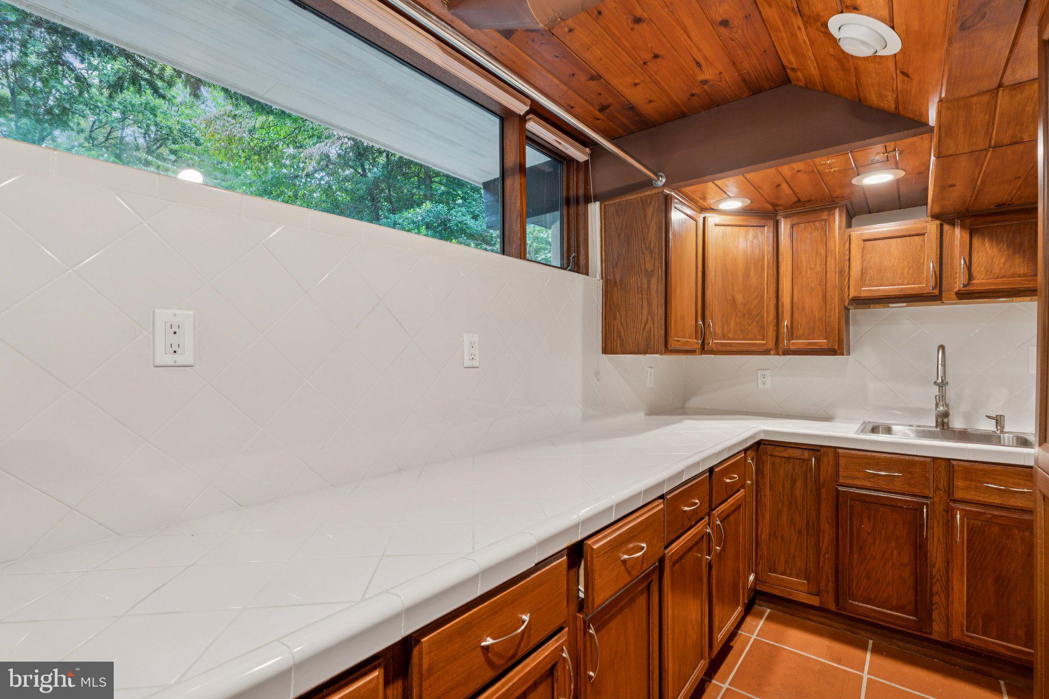 11428 Purple Beech Drive Reston, VA 20191 - Photo 22 of 52 a kitchen with a sink and cabinets