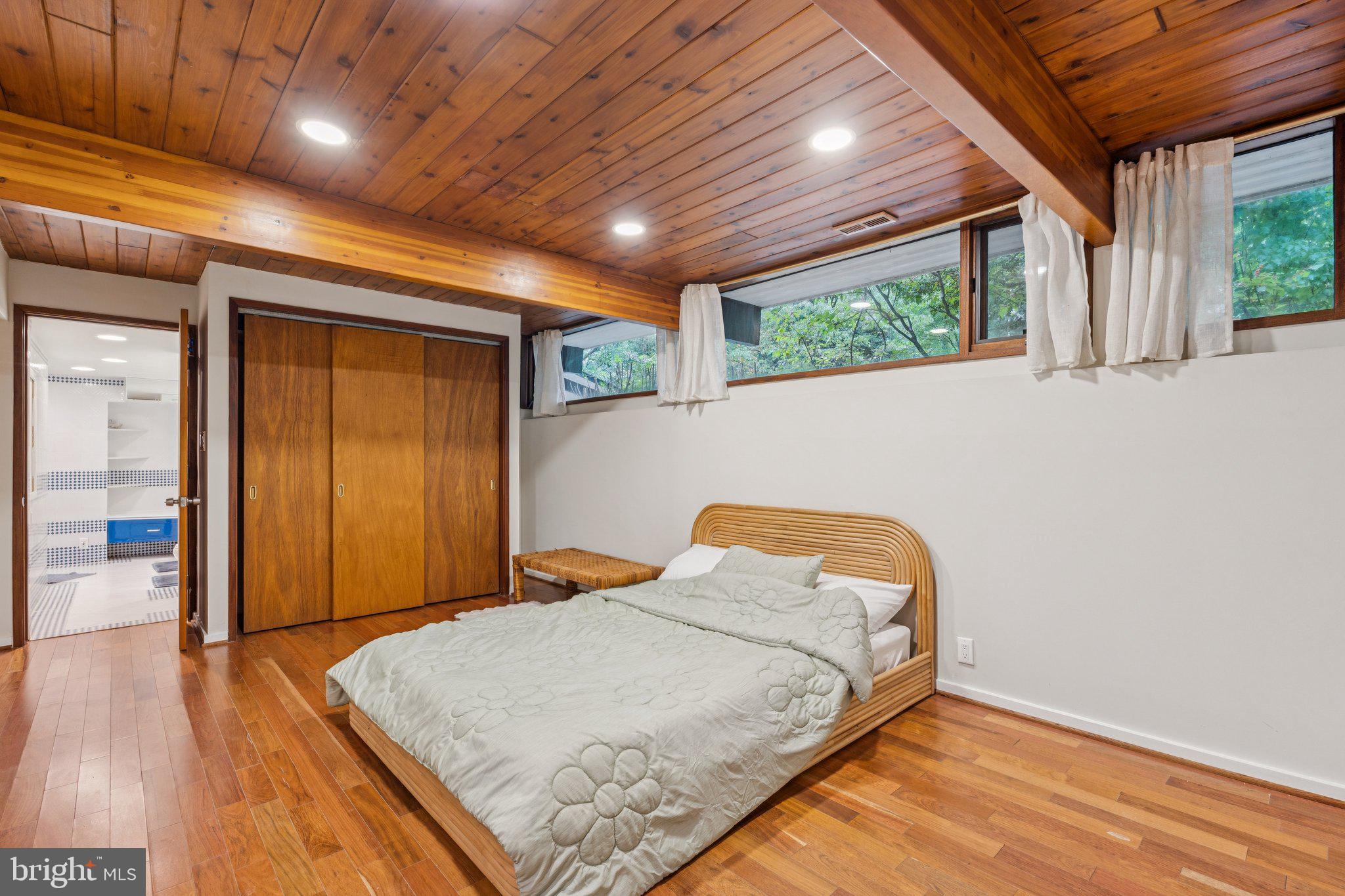 11428 Purple Beech Drive Reston, VA 20191 - Photo 23 of 52 a bedroom with a bed and wooden floor